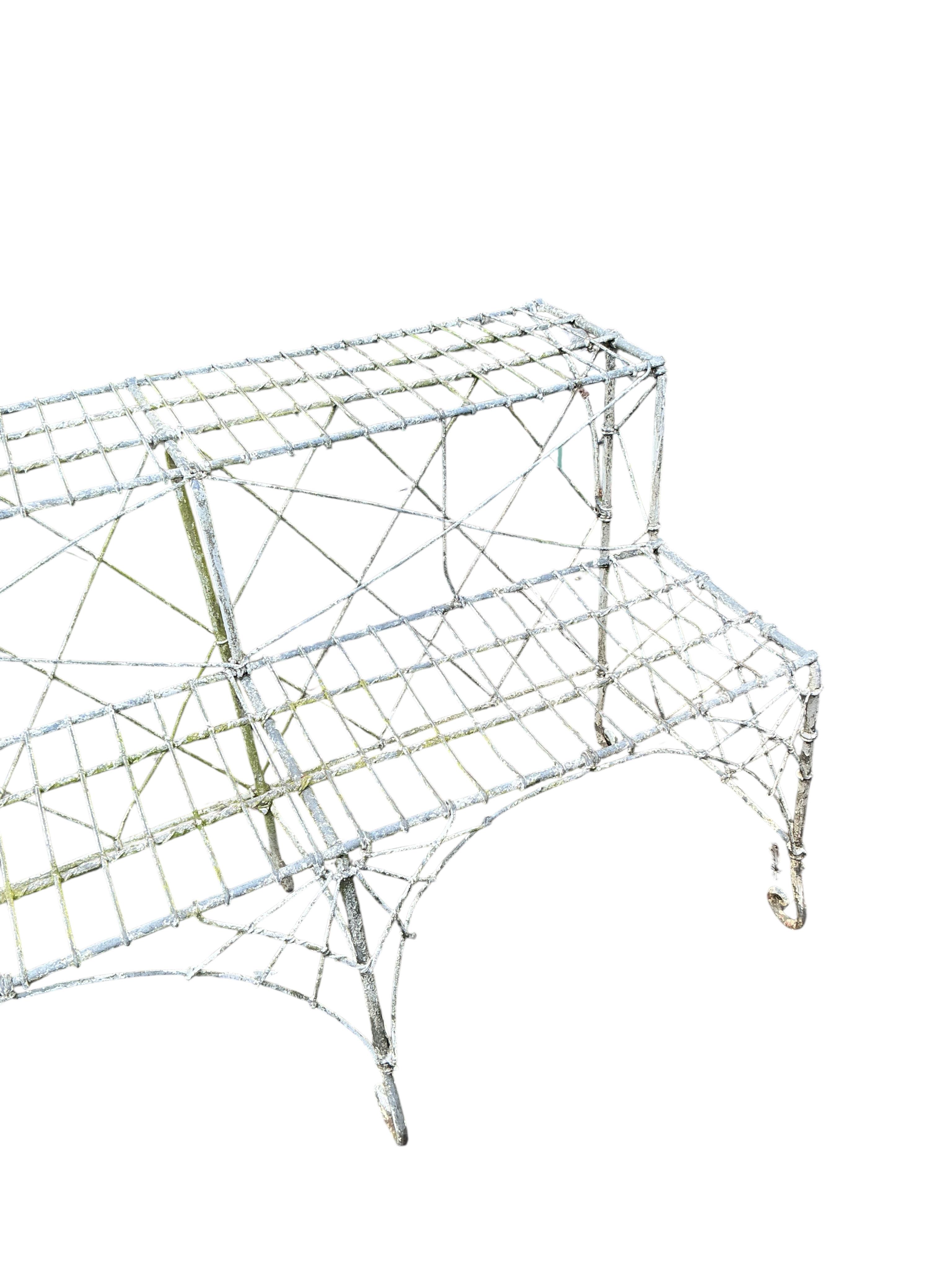 A Victorian painted wire work two tier pot stand, width 180cm, height 63cm